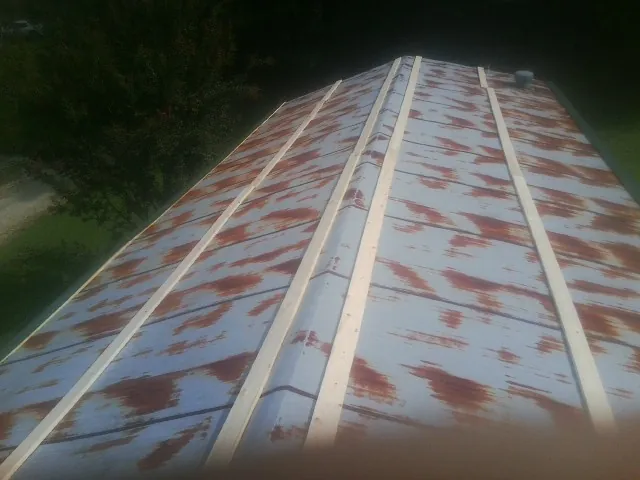 Rusted metal roof panels with new wood purlins before replacement — Storm Damage Roof Repair in Alexander by Roofing Brothers